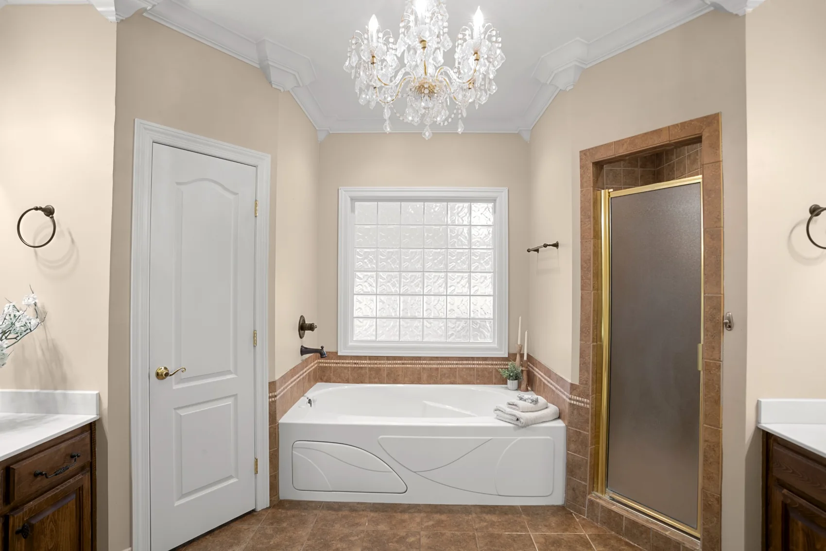 Bathroom with soaking tub, glass-block window and chandelier