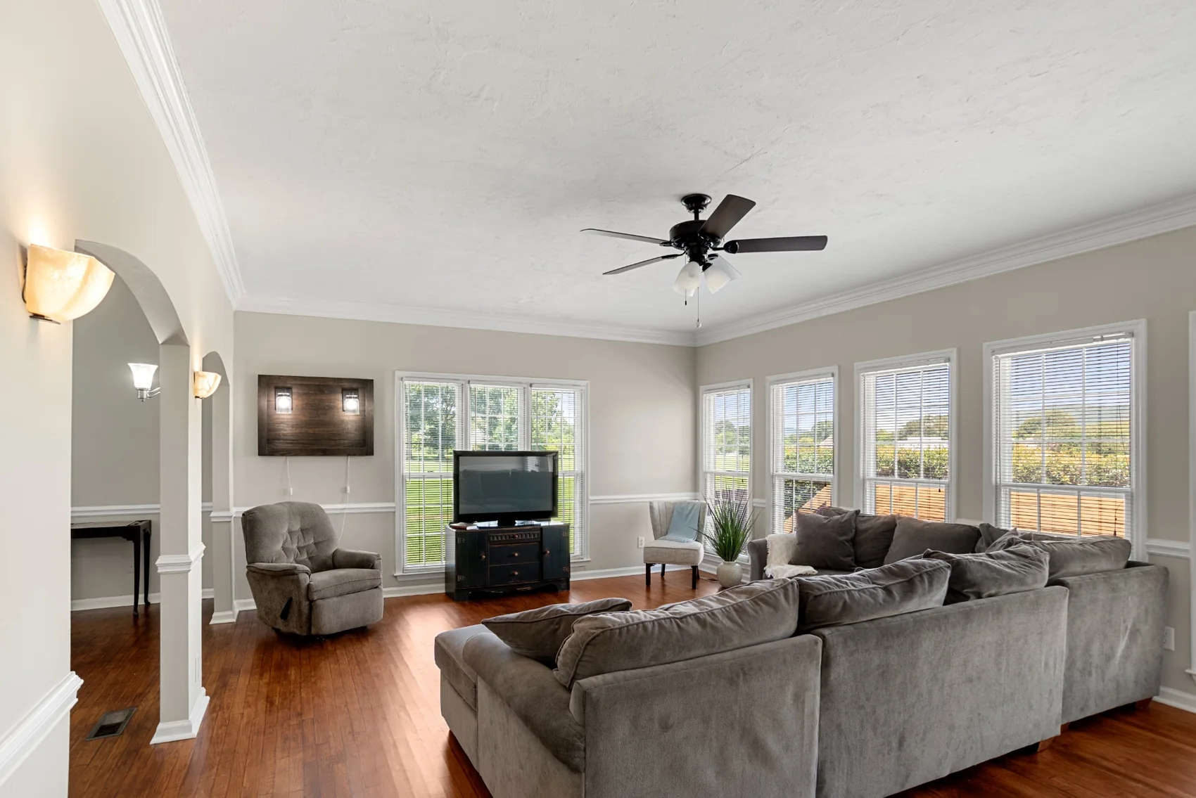 Bright living room with multiple windows and wood floors